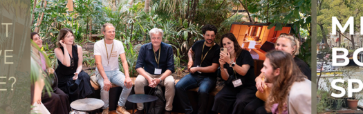 Mind-Body-Space Symposium logo and group photo with multiple participants sitting in a semi-circle in a hotel courtyard, asking